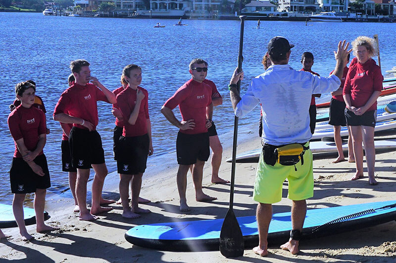 Stand Up Paddle Board Instructor taking students for a SUP lesson and tour
